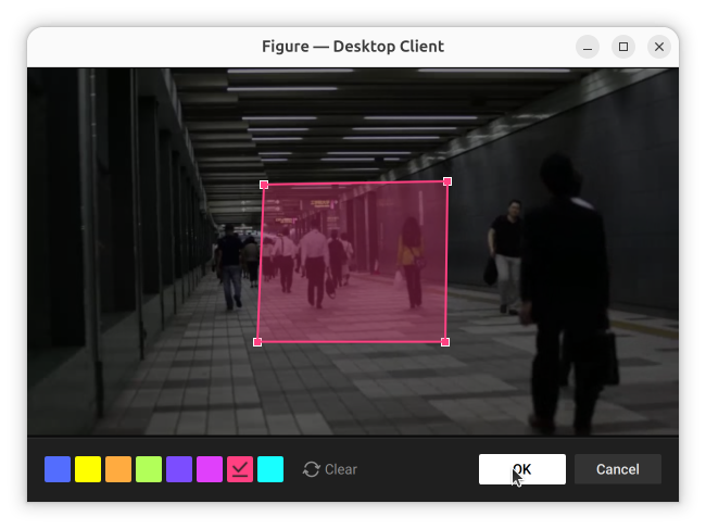Figure editor dialog with a pink rectangle drawn over part of a crowded corridor camera image, resize handles visible